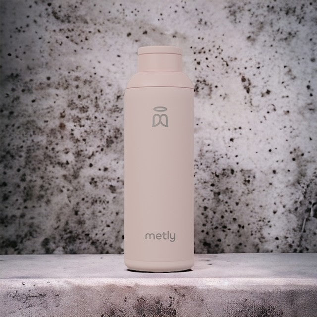 Metly Blush Pink 500ml filtered water bottle presented against a textured, dark background, emphasizing the sleek and modern design of the bottle.