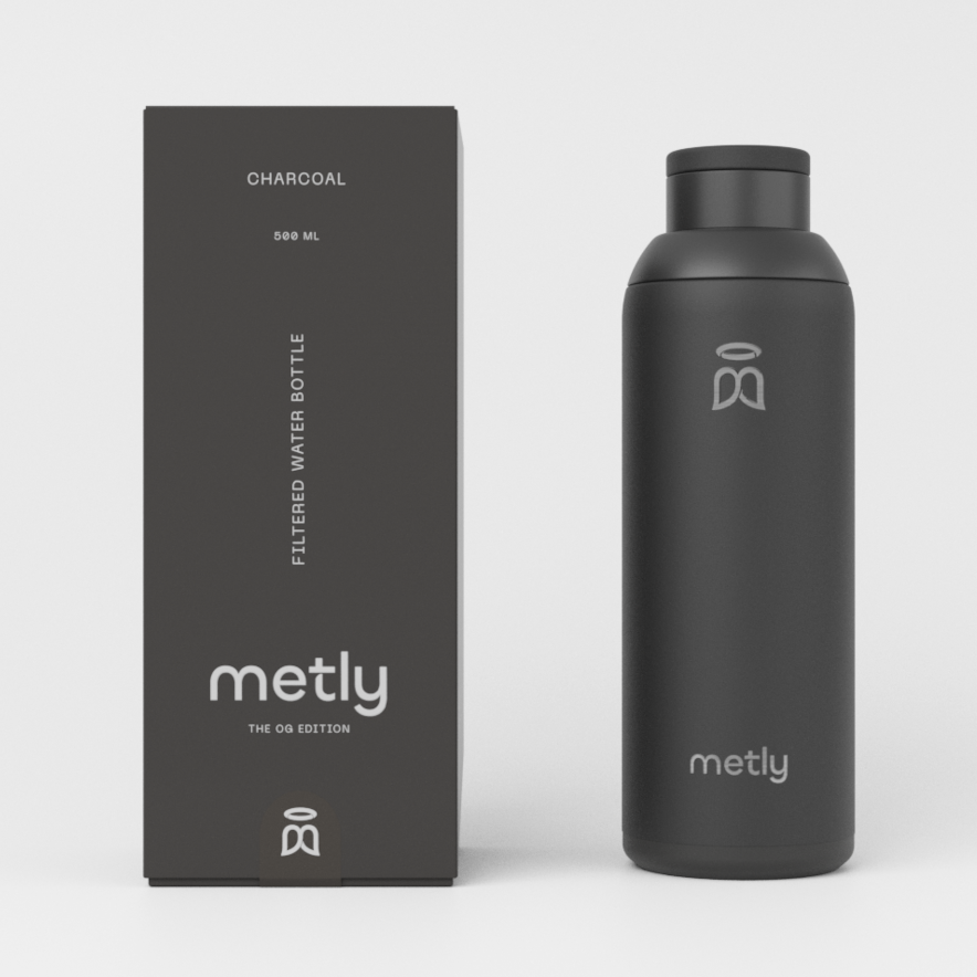 Metly Charcoal 500ml filtered water bottle displayed next to its dark packaging, featuring the OG Edition branding and specifying a 500ml capacity