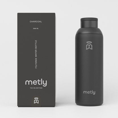 Metly Charcoal 500ml filtered water bottle displayed next to its dark packaging, featuring the OG Edition branding and specifying a 500ml capacity