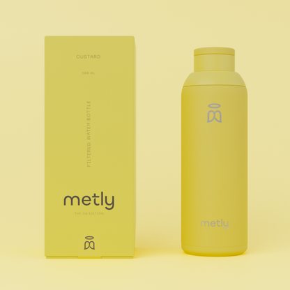 Metly Custard 500ml filtered water bottle displayed next to its matching yellow packaging, featuring the OG Edition branding and specifying a 500ml capacity.