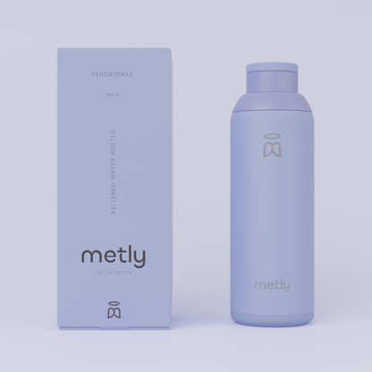 Metly Periwinkle 500ml filtered water bottle displayed next to its matching soft blue packaging, featuring the OG Edition branding and specifying a 500ml capacity